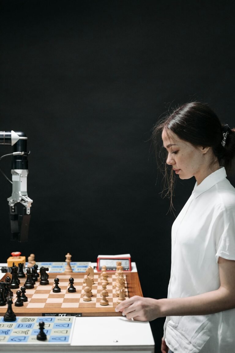 A woman engaged in a strategic chess game with a robotic arm, highlighting AI innovation.